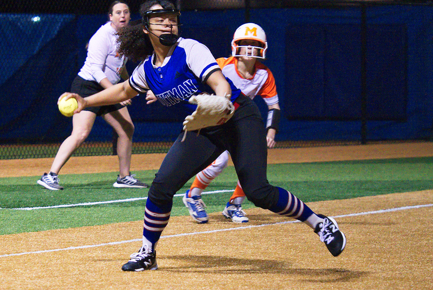 Ashely Davis of Quitman fakes a throw to first base before turning to trap the Mineola runner on third. The throw to third was dropped allowing the Mineola runner to score. (Monitor photo by Sam Major)